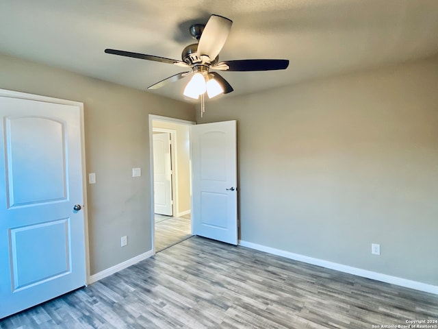 unfurnished bedroom featuring ceiling fan and light hardwood / wood-style flooring