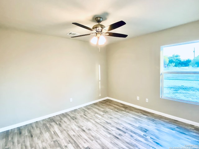 spare room with ceiling fan and light hardwood / wood-style floors