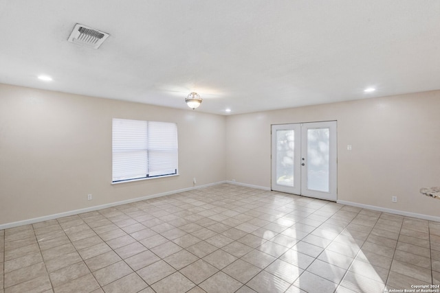 unfurnished room featuring french doors and light tile patterned flooring