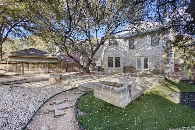 rear view of house featuring a patio, french doors, and a yard