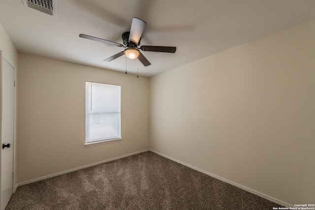 carpeted empty room featuring ceiling fan