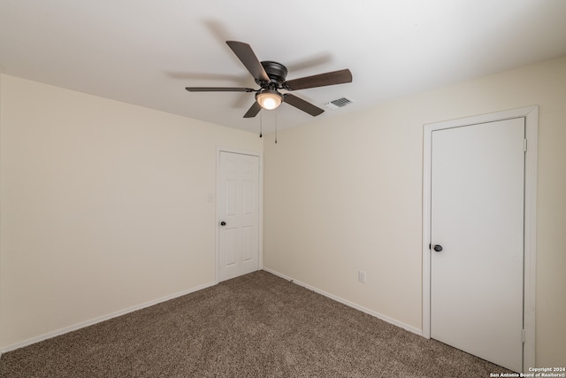 spare room featuring carpet floors and ceiling fan