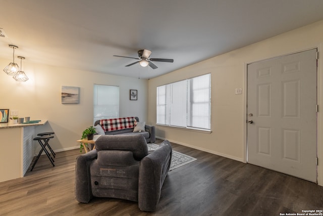 sitting room featuring dark wood-type flooring and ceiling fan