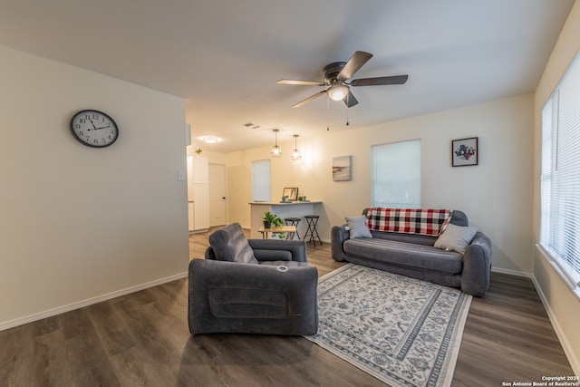 living room with dark hardwood / wood-style floors and ceiling fan