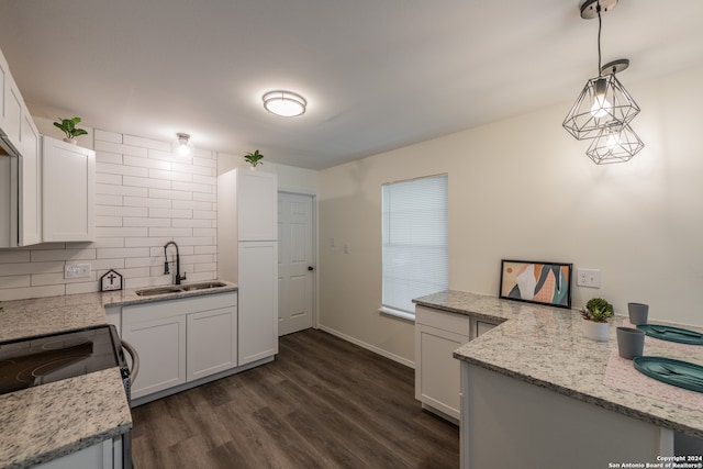 kitchen with white cabinets, decorative light fixtures, sink, and dark hardwood / wood-style flooring