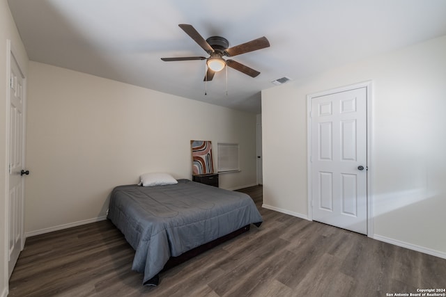 bedroom with ceiling fan and dark hardwood / wood-style floors