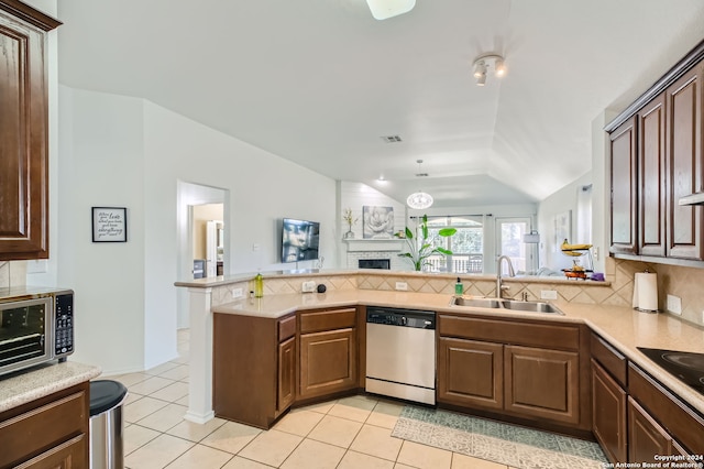 kitchen featuring appliances with stainless steel finishes, sink, backsplash, kitchen peninsula, and light tile patterned floors