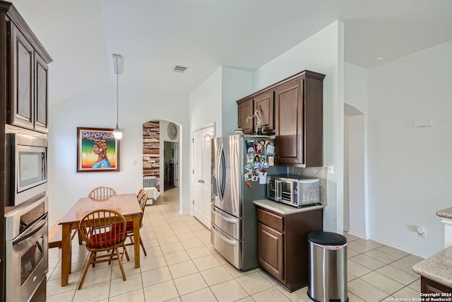 kitchen featuring decorative backsplash, hanging light fixtures, light tile patterned floors, appliances with stainless steel finishes, and dark brown cabinetry