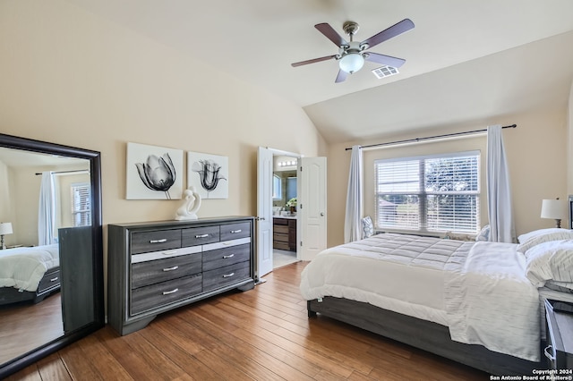 bedroom with connected bathroom, ceiling fan, wood-type flooring, and vaulted ceiling