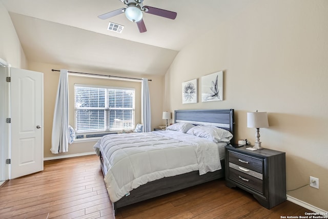 bedroom with lofted ceiling, hardwood / wood-style floors, and ceiling fan