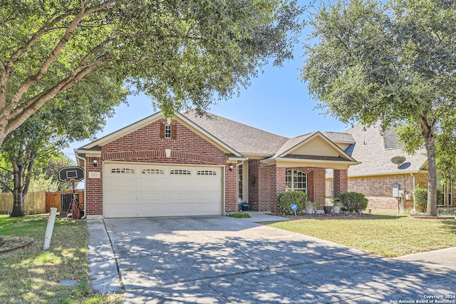 view of front of property with a front yard and a garage