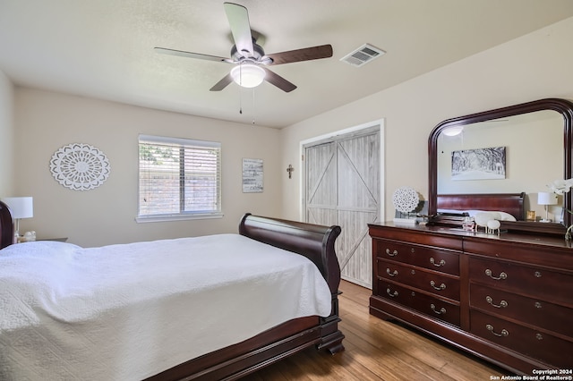 bedroom with ceiling fan and light hardwood / wood-style floors