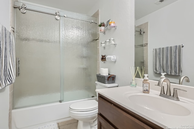 full bathroom with vanity, toilet, tile patterned floors, and bath / shower combo with glass door