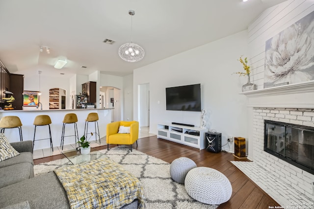 living room with a fireplace and dark hardwood / wood-style floors