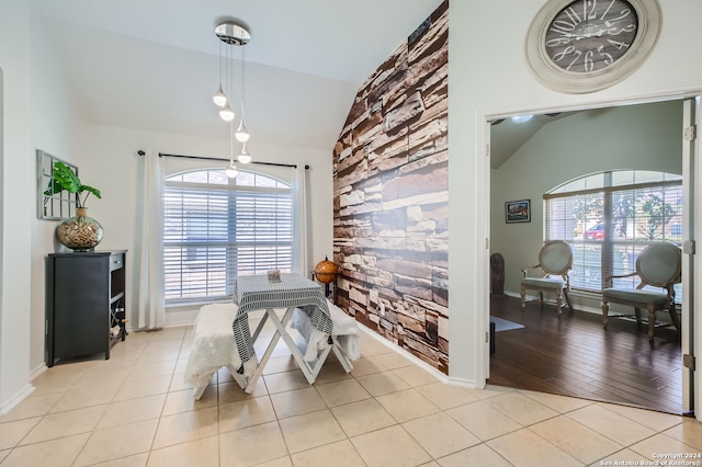 dining space with light hardwood / wood-style flooring, vaulted ceiling, and a wealth of natural light