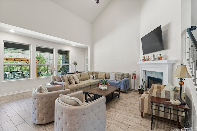 living room featuring light hardwood / wood-style floors and high vaulted ceiling