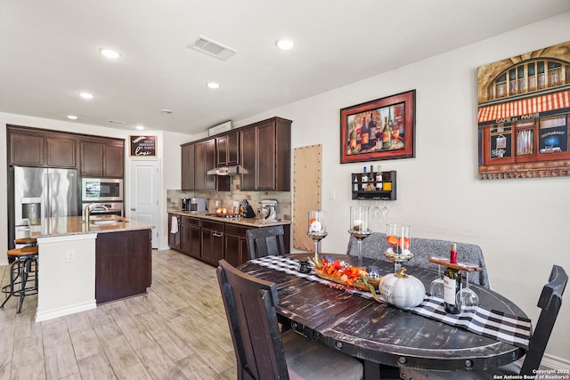 dining space with light hardwood / wood-style flooring