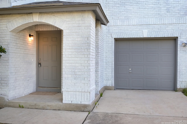 doorway to property with a garage