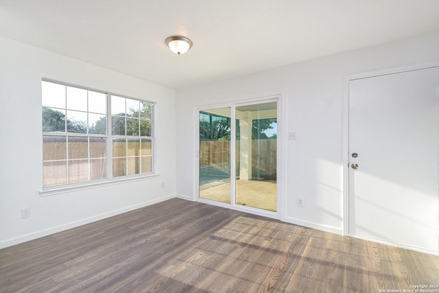 spare room with dark hardwood / wood-style floors