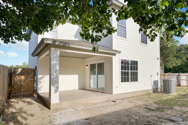 back of house with central air condition unit and a patio area