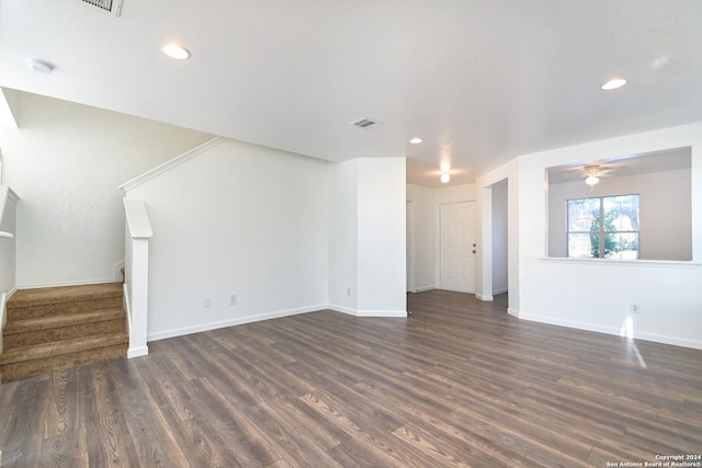 unfurnished living room with ceiling fan and dark hardwood / wood-style flooring