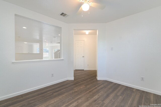 spare room with dark hardwood / wood-style floors and ceiling fan