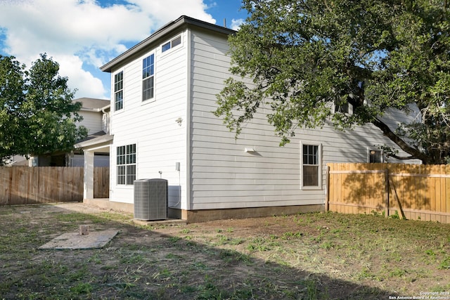 back of house with central air condition unit