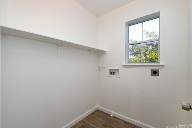 clothes washing area featuring gas dryer hookup, hookup for an electric dryer, washer hookup, and dark hardwood / wood-style flooring