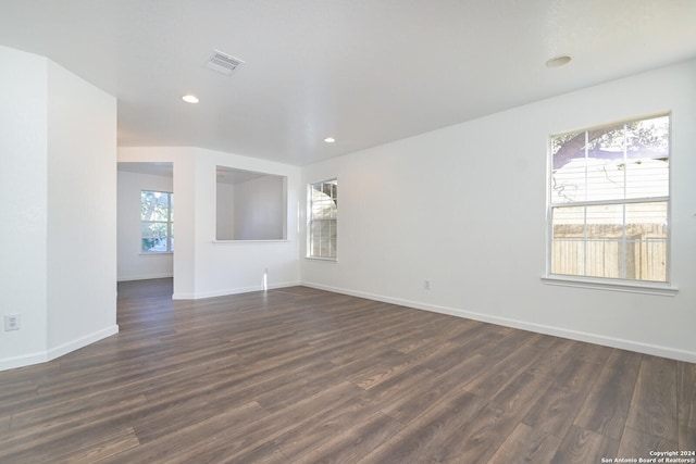 empty room with dark wood-type flooring