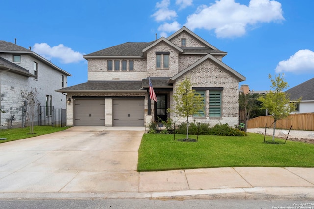 view of front of house featuring a front yard and a garage