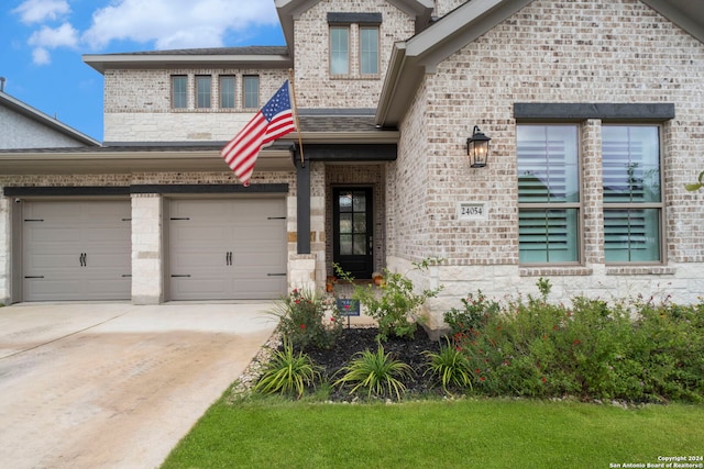 24054 Sidehill Lie, San Antonio, TX 78261 - view of front of house featuring brick siding, driveway, and a garage