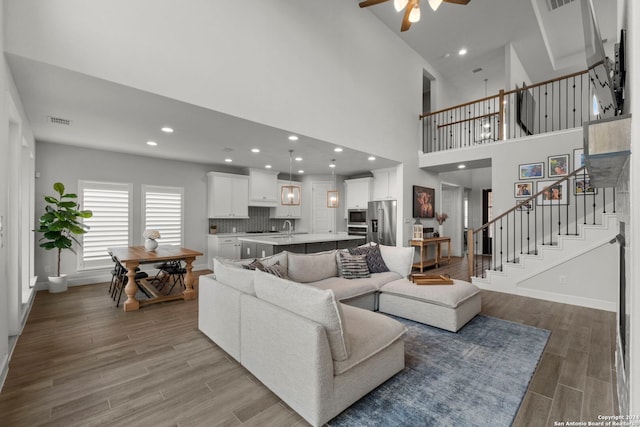 24054 Sidehill Lie, San Antonio, TX 78261 - living room with ceiling fan, stairway, wood finished floors, baseboards, and recessed lighting