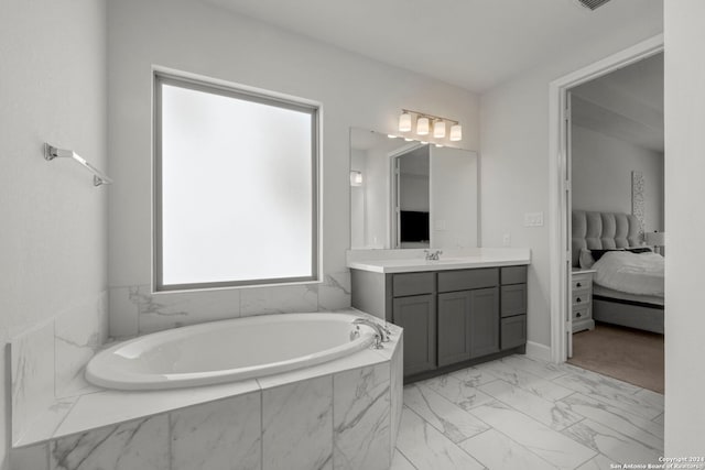 bathroom featuring vanity and tiled tub