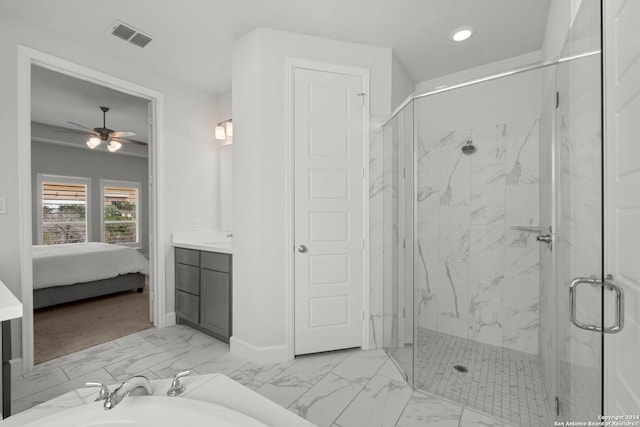 bathroom with a shower with door, vanity, and ceiling fan