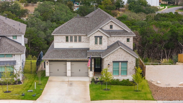 view of front of property with a front yard and a garage