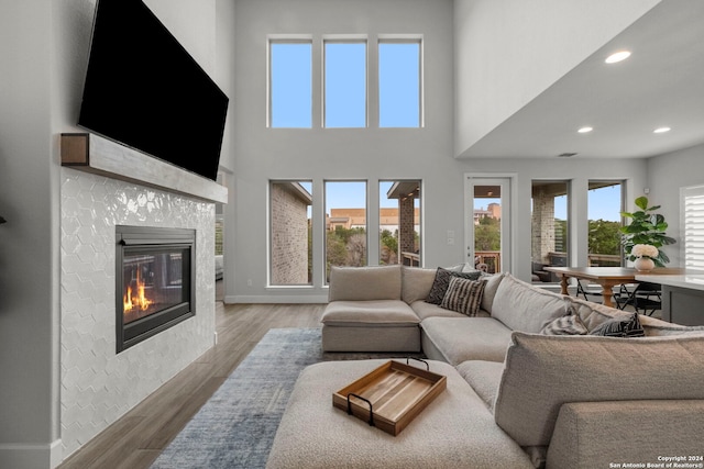 24054 Sidehill Lie, San Antonio, TX 78261 - living room featuring a tiled fireplace, wood finished floors, recessed lighting, and baseboards