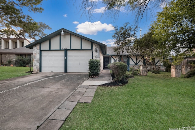 view of front of property with a front lawn and a garage