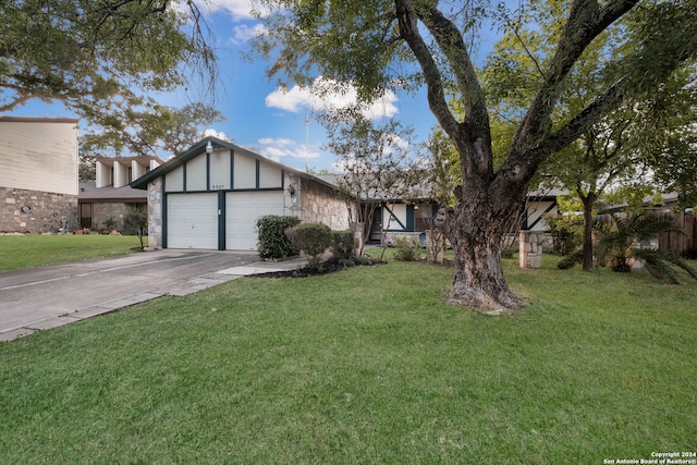 view of front of property with a front lawn and a garage