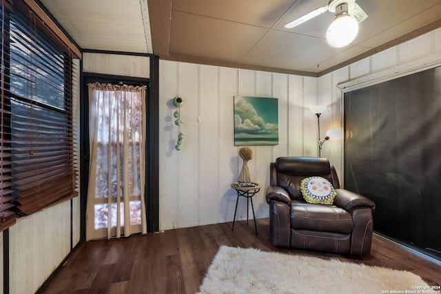 sitting room with ceiling fan and wood-type flooring