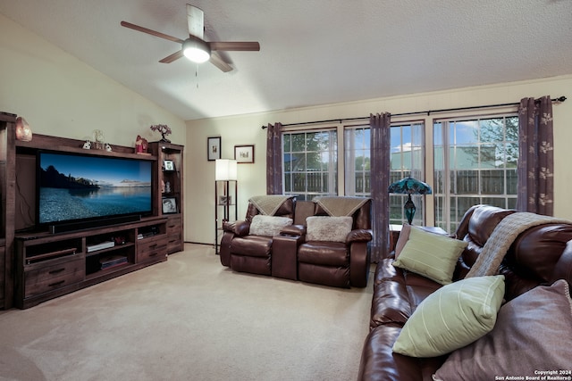 living room featuring a textured ceiling, vaulted ceiling, light colored carpet, and ceiling fan