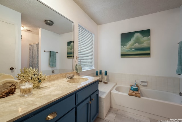 bathroom with vanity, plus walk in shower, a textured ceiling, and tile patterned flooring