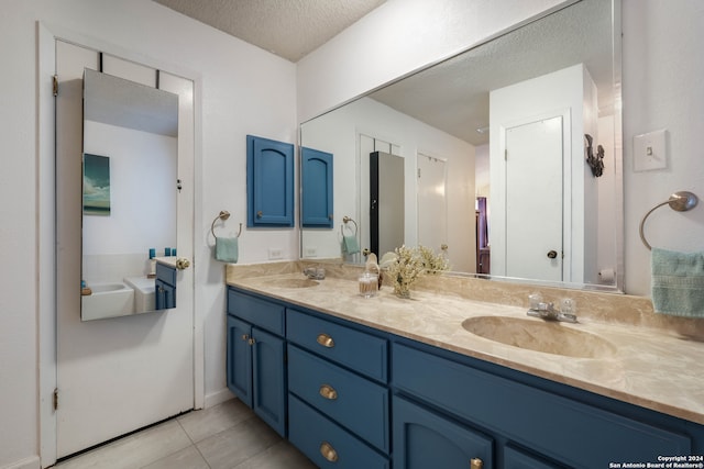 bathroom featuring vanity, a textured ceiling, and tile patterned floors