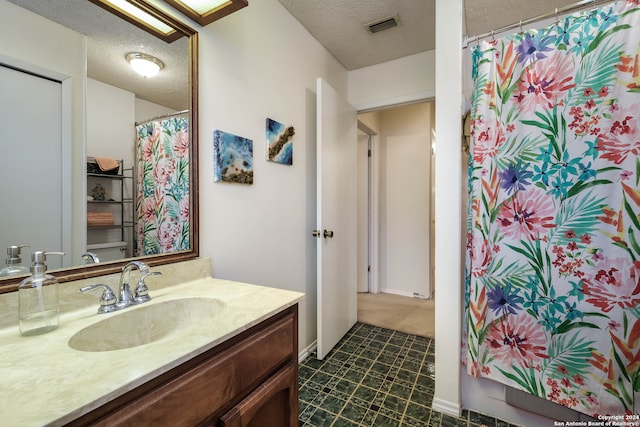 bathroom with vanity and a textured ceiling