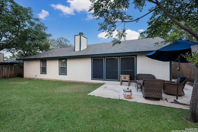 rear view of house with a yard and a patio area