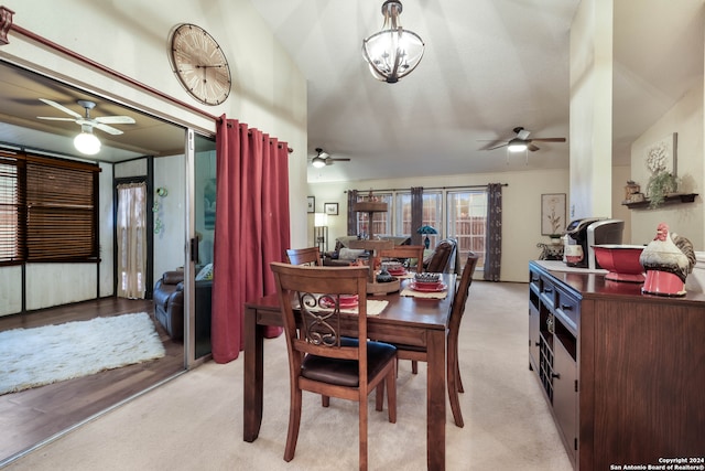 dining room with lofted ceiling and light carpet