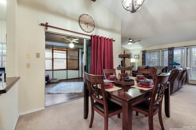 carpeted dining room featuring ceiling fan and vaulted ceiling