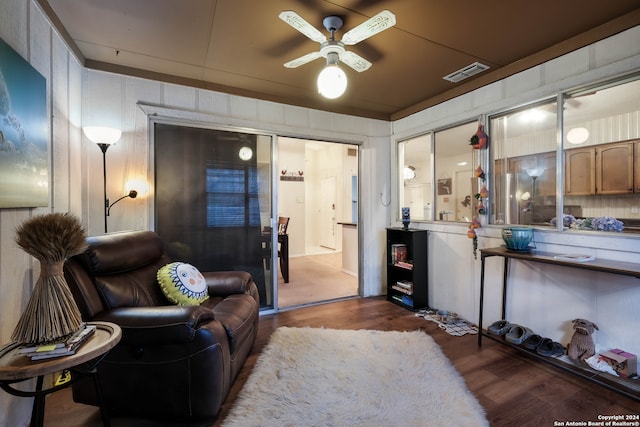 living room with ceiling fan and dark hardwood / wood-style flooring