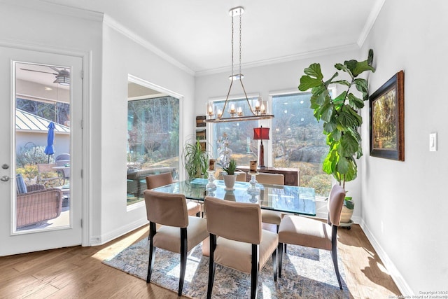 dining area with crown molding, hardwood / wood-style floors, and a chandelier