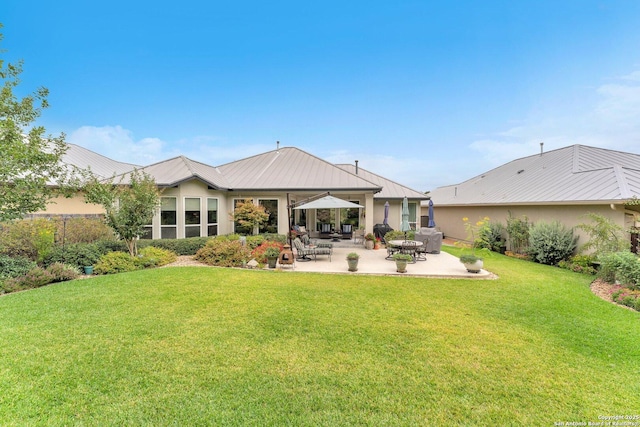 rear view of property featuring a patio and a lawn