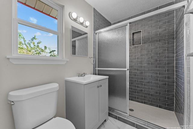 bathroom with vanity, toilet, and an enclosed shower